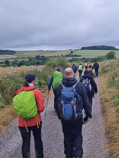 Dentists in hiking gear walking along a countryside track