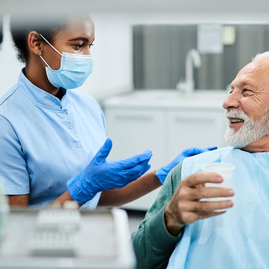 Dental nurse talking to patient