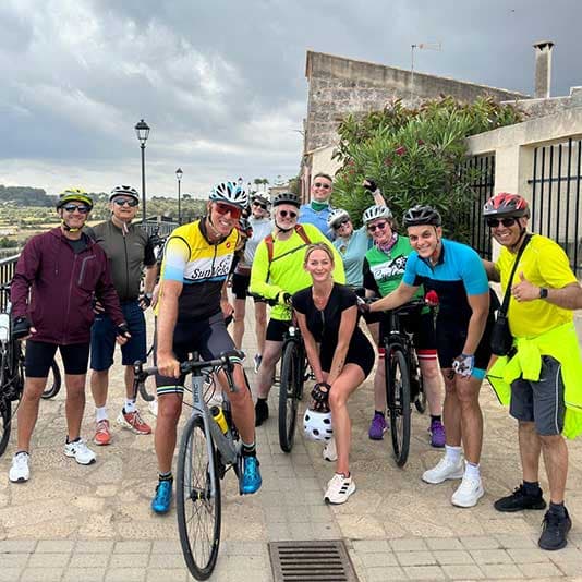 Denplan dentists posing with their bikes on a terrace